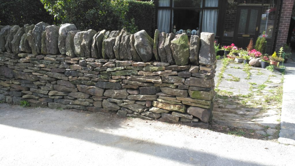 The finished repair to a dry stone wall in middle of Longridge