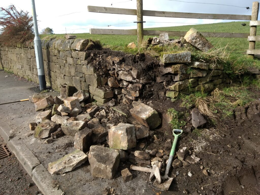 dry stone wall in mellor dmaged