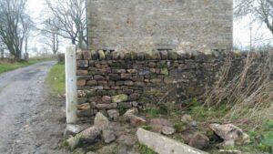 dry stone wall repair in forest of bowland on gateway after repair