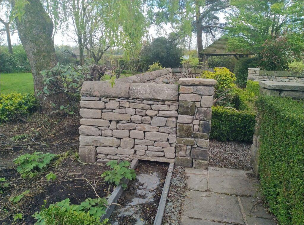 Shows corner of a reclaimed dry stone wall with pillar that i did near Preston, Lancashire.